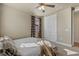 Comfortable bedroom with neutral tones, ceiling fan, and bright natural light at 8358 Dunham Station Dr, Tampa, FL 33647