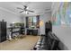 Spacious bedroom featuring a desk area, comfortable seating, and a large window for ample lighting at 8358 Dunham Station Dr, Tampa, FL 33647