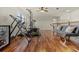 Large bonus room with hardwood floors, ample space for lounging, and workout equipment at 8358 Dunham Station Dr, Tampa, FL 33647