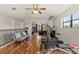 Spacious bonus room with hardwood floors and exercise equipment; perfect for a home gym at 8358 Dunham Station Dr, Tampa, FL 33647