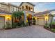 Stunning home with a circular brick driveway, three-car garage, and manicured landscaping at 8358 Dunham Station Dr, Tampa, FL 33647