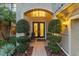 Inviting front entrance with double doors, manicured bushes, and brick walkway at 8358 Dunham Station Dr, Tampa, FL 33647
