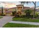 Beautiful home featuring a tile roof, well-kept lawn, and lush landscaping at 8358 Dunham Station Dr, Tampa, FL 33647