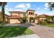 Gorgeous home featuring a tile roof, well-kept lawn, and lush landscaping at 8358 Dunham Station Dr, Tampa, FL 33647