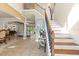 Grand foyer with staircase, tile flooring, columns, and open view to living spaces at 8358 Dunham Station Dr, Tampa, FL 33647