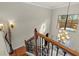 Elegant foyer with hardwood floors, wrought iron staircase, and a grand chandelier at 8358 Dunham Station Dr, Tampa, FL 33647