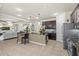 Open kitchen featuring an island with seating, stainless appliances, dark wood cabinetry, and tile backsplash at 8358 Dunham Station Dr, Tampa, FL 33647