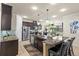 Kitchen features an island with seating and pendant lighting, stainless appliances, and dark wood cabinetry at 8358 Dunham Station Dr, Tampa, FL 33647