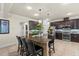 Kitchen features an island with seating and pendant lighting, complemented by dark wood cabinetry and tiled floors at 8358 Dunham Station Dr, Tampa, FL 33647