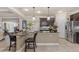 Kitchen features an island with seating and pendant lighting, stainless appliances, and dark wood cabinetry at 8358 Dunham Station Dr, Tampa, FL 33647
