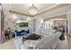 Bright living room featuring a gorgeous chandelier and a modern entertainment center with marble accent wall at 8358 Dunham Station Dr, Tampa, FL 33647