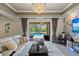 This living room has a chandelier, glass doors to the pool, and tile flooring at 8358 Dunham Station Dr, Tampa, FL 33647