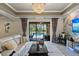 The living room features doors that open to a covered patio and in-ground pool at 8358 Dunham Station Dr, Tampa, FL 33647