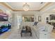 Bright living room featuring a gorgeous chandelier and a modern entertainment center with marble accent wall at 8358 Dunham Station Dr, Tampa, FL 33647