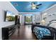 Comfortable main bedroom features hardwood floors, custom ceiling, and stylish decor at 8358 Dunham Station Dr, Tampa, FL 33647
