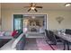 Spacious covered patio with a ceiling fan, an outdoor table and chairs, and a comfortable seating area at 8358 Dunham Station Dr, Tampa, FL 33647