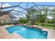 Enclosed pool and spa surrounded by lush tropical landscaping creates a private oasis at 8358 Dunham Station Dr, Tampa, FL 33647