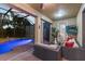 Relaxing outdoor patio with a comfortable lounge area and access to a screened-in pool and hot tub at 8358 Dunham Station Dr, Tampa, FL 33647