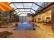 A screened lanai with outdoor seating overlooks the inviting pool, and spa at 8358 Dunham Station Dr, Tampa, FL 33647