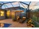 An inviting poolside with lounge chairs awaits relaxation within a screened lanai and serene green views at 8358 Dunham Station Dr, Tampa, FL 33647