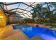 The shimmering pool and spa feature a screened enclosure and scenic backyard views, perfect for relaxation at 8358 Dunham Station Dr, Tampa, FL 33647