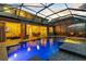 Screened-in pool and hot tub with a brick patio, outdoor seating, and open access to the home's interior at 8358 Dunham Station Dr, Tampa, FL 33647