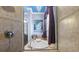 Inside the shower stall a soaking tub is featured with a granite tile surround at 8358 Dunham Station Dr, Tampa, FL 33647