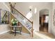 Beautiful staircase with wood and iron accents, bathed in natural light at 8358 Dunham Station Dr, Tampa, FL 33647