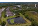 Picturesque aerial view of homes nestled amongst lush trees and serene ponds at 8624 Snowy Owl Way, Tampa, FL 33647