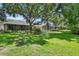 Expansive backyard view of multiple screened patios, mature trees and lush landscaping at 8624 Snowy Owl Way, Tampa, FL 33647