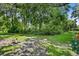 Spacious backyard with mature trees and lush greenery, offering privacy and natural beauty at 8624 Snowy Owl Way, Tampa, FL 33647