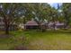 An inviting backyard featuring a screened in porch and meticulously maintained landscaping at 8624 Snowy Owl Way, Tampa, FL 33647