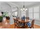 Bright dining room featuring a round table, statement chairs, and white plantation shutters at 8624 Snowy Owl Way, Tampa, FL 33647