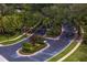 Aerial view of gated community entrance with lush landscaping and palm trees at 8624 Snowy Owl Way, Tampa, FL 33647