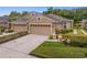 Charming home featuring a well-manicured lawn and a two-car garage at 8624 Snowy Owl Way, Tampa, FL 33647