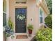Charming front door with a wreath, plants, and stone accents for an inviting entrance at 8624 Snowy Owl Way, Tampa, FL 33647