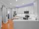 Modern kitchen featuring white cabinets, stainless steel appliances, and an island with seating at 8624 Snowy Owl Way, Tampa, FL 33647