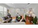 Open-concept living room featuring hardwood floors, cozy seating, and elegant decor at 8624 Snowy Owl Way, Tampa, FL 33647