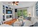 Living room featuring sliding glass doors to the lanai, a modern fireplace, and bright furniture at 8624 Snowy Owl Way, Tampa, FL 33647
