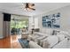 Bright living room with comfortable seating, an outdoor lanai, and an eye-catching art piece at 8624 Snowy Owl Way, Tampa, FL 33647