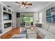 Cozy living room boasts bright furniture, sliding doors to the lanai, and a modern fireplace at 8624 Snowy Owl Way, Tampa, FL 33647