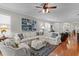 Bright and airy living room featuring hardwood floors, white sofas, and stylish accents at 8624 Snowy Owl Way, Tampa, FL 33647