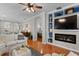 Bright living room features hardwood floors, modern fireplace, and custom built-in shelving at 8624 Snowy Owl Way, Tampa, FL 33647