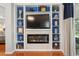 Elegant living room boasts a fireplace with shelving and lovely blue accents at 8624 Snowy Owl Way, Tampa, FL 33647