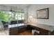 Office features built-in desk, chair, and view of the screened-in porch at 8624 Snowy Owl Way, Tampa, FL 33647