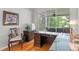 Office with a built-in desk, chair, and view of the screened-in porch at 8624 Snowy Owl Way, Tampa, FL 33647