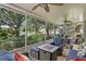 Inviting screened-in patio area with comfortable seating and ceiling fans, perfect for relaxing outdoors at 8624 Snowy Owl Way, Tampa, FL 33647