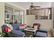 Enclosed patio features a cozy seating area with cushioned wicker furniture and a ceiling fan at 8624 Snowy Owl Way, Tampa, FL 33647
