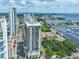 Stunning aerial view highlighting a modern residential tower near a picturesque marina and bay, with city skyline views at 1 Beach Se Dr # 811, St Petersburg, FL 33701