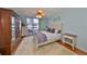 Bright bedroom with a ceiling fan and sliding glass door to the balcony at 1 Beach Se Dr # 811, St Petersburg, FL 33701